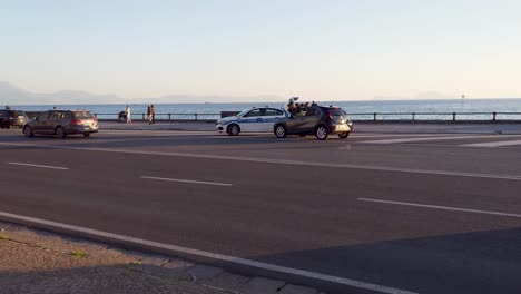 Police-car-with-flashing-lights-controlling-vehicle-along-the-road---Gulf-of-Naples,-Italy