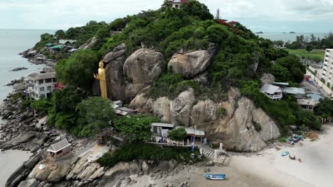 Aerial-view-of-Buddha-and-shoreline-of-Chopstick-Mountain,-also-called-Monkey-Mountain,-in-Hua-Hin,-Thailand