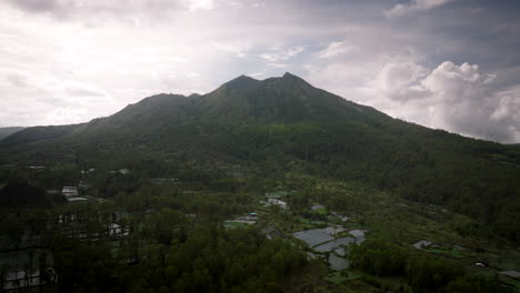 Mount-Batur-Volcano-With-Dense-Forests-And-Fields-During-Sunrise-In-Bali,-Indonesia