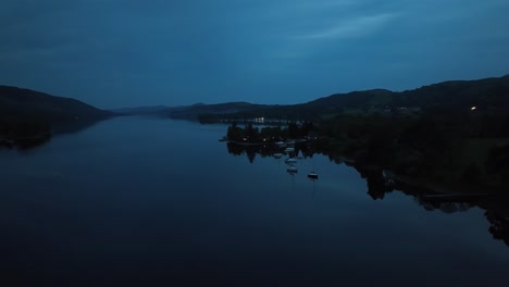 Flying-over-the-lake-in-the-night-in-Lake-District,-England