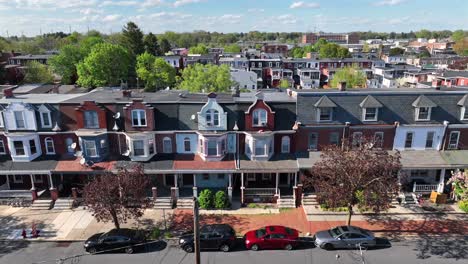 Historic-row-houses-with-distinct-architectural-details,-tree-lined-streets,-and-parked-cars