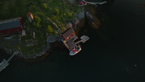 Tiny-pier-of-Reine-with-small-ship,-aerial-drone-view