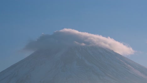 Close-Up-Zoom-of-Majestic-Mount-Fuji-with-clouds-rolling-over-the-top-in-Japan