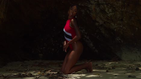 In-the-Caribbean,-on-the-island-of-Trinidad,-a-young-girl-in-a-Trinidad-flag-bikini-is-on-a-north-coast-beach