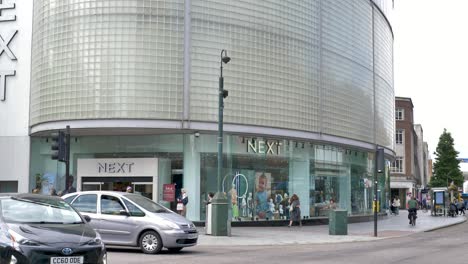 Exterior-of-large-NEXT-store-with-modern-facade-and-customer-entrance,-Exeter-Devon-UK,-June-2024