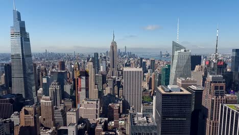 The-camera-turns-slowly-down-to-up-and-focuses-on-the-Empire-State-Building-which-is-in-the-center-of-the-frame,-with-other-skyscrapers-on-both-sides