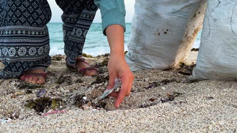 wonderful-young-lady-picking-up-trash-from-glorious-sandy-beach-sunset-blue-waves-magnificent-panoramic-view-inspiring-scene-highlights-importance-keeping-beach-clean-preserving-natural-beauty-iran