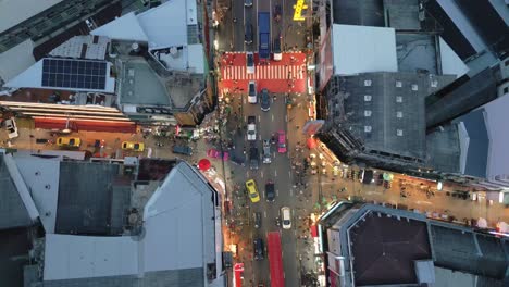 Aerial-top-down-of-Chinatown-Bangkok-famous-street-food-vendor-neon-sign-road