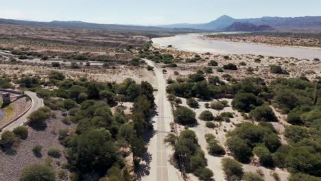 Drone-view-capturing-the-exact-moment-where-the-pavement-ends-on-Ruta-40-near-Cafayate,-Salta,-Argentina