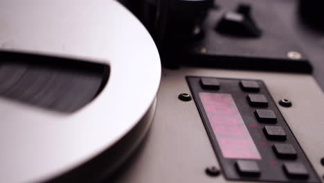 Spinning-Reel-to-Reel-Audio-Tape-on-Professional-Magnetophone-Player-Recorder,-Close-Up