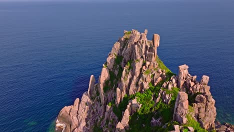 This-footage-captures-the-majestic-rocky-peaks-and-lush-greenery-of-a-small-island-on-the-way-to-Da-Nang,-Vietnam