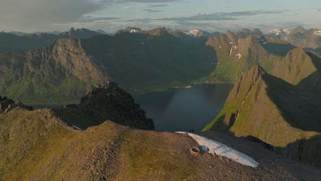 Scenic-aerial-view-of-Husfjellet-mountain-hike-at-sunset-in-Senja,-Norway