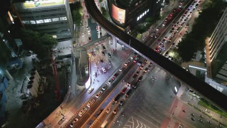 Aerial-Drone-Fly-Above-Bangkok-City-Center-at-Night,-Street-Traffic-and-High-Buildings