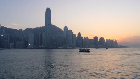 Passenger-ferry-transportation,-Victoria-Harbour-waterfront,-sunset-scene