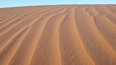 Wavy-sand-dunes-creating-an-endless-desert-landscape-during-sunset