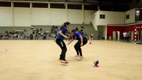 Couple-of-female-athletes-with-handball-technical-training