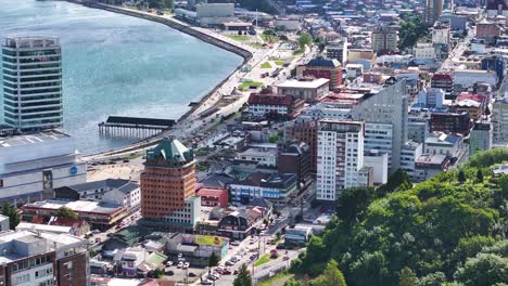 Aerial-View-of-Puerto-Montt,-Chile-City-Promenade,-Waterfront-Buildings-on-Sunny-Day-60fps