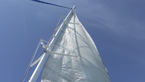 Fore-sail-of-catamaran-ship-in-wind,-blue-sky