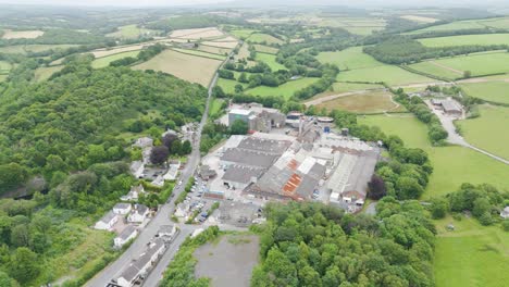 Aerial-of-Lifton,-Devon-countryside-and-Ambrosia-factory-complex