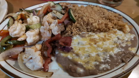 Close-up-shot-of-a-tasty-meal-in-a-restaurant,-full-plate-with-seafood,-vegetables-and-more