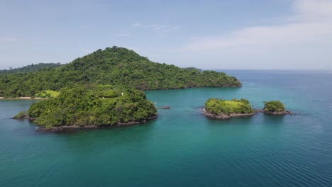 Panama's-Coiba-Island-with-lush-green-landscape-surrounded-by-clear-blue-ocean-water