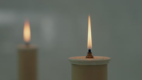 Two-lit-candles-with-a-calm-flame,-creating-a-serene-and-peaceful-ambiance