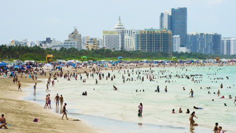 Miami-City-Skyline-in-Distance-as-People-Relax-on-Miami-Beach