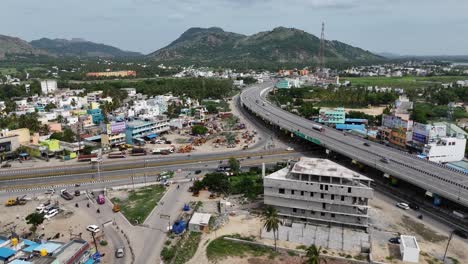 Aerial-shot-capturing-the-highway-passing-through-a-quaint-village