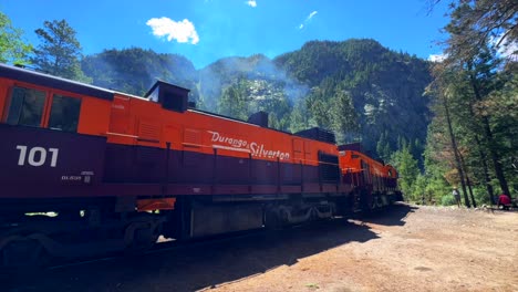 Durango-and-Silverton-Train-Narrow-Gauge-Railroad-steam-coal-Colorado-Rocky-Mountains-trains-Neddleton-Need-Creek-Chicago-Basin-Purgatory-Trail-Summer-July-bluesky-slow-pan-right-motion