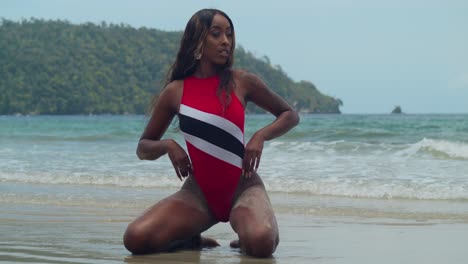 A-bikini-clad-young-Trinidadian-girl-on-the-tropical-island-of-Trinidad's-beach-with-ocean-waves-in-the-background