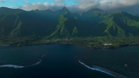 Perfect-golden-hour-sunset-towering-mountain-peaks-surf-reef-break-channel-Teahupoo-Wave-Tahiti-French-Polynesia-aerial-drone-view-incredible-island-landscape-Moorea-Bora-Bora-Papeete-backwards-pan