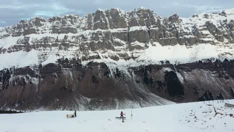 drone-flight-in-a-beautiful-snowy-landscape-with-a-cross-on-the-mountain-top