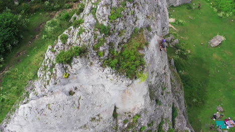 Drone-shot-of-rock-climbing-in-Zborow-Mountain-limestone-cliff-surrounded-by-natural-forest