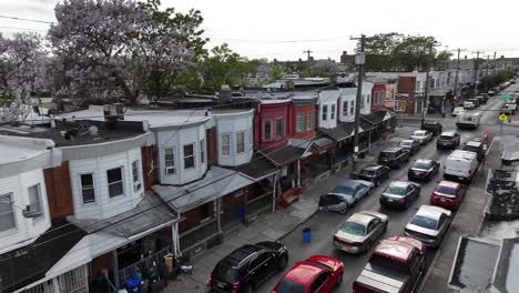 Traffic-jam-in-american-street-with-row-of-houses-and-blossoming-trees