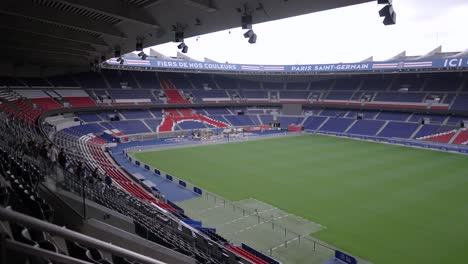 Soccer-field-stadium-at-Parc-des-Princes-with-Fans-on-Seats-home-of-Paris-Saint-Germain-Football-team,-Aerial-dolly-in-shot