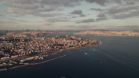 Aerial-shot-of-harbor-pier-and-city-view-of-Instabul-during-blackened-clouds,-Türkiye