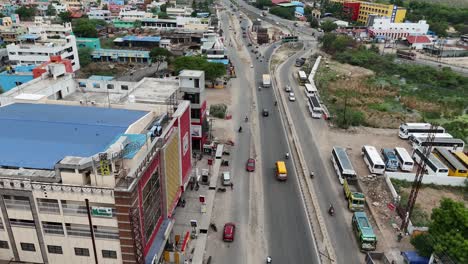 Daytime-drone-footage-of-the-highway-during-a-holiday,-showing-lighter-than-usual-traffic-and-a-more-relaxed-atmosphere