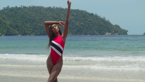 On-the-beach-of-Trinidad's-tropical-island,-a-young-girl-in-a-bikini-with-blue-skies-in-the-background