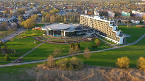 Tervise-Paradiis-Hotel-in-aerial-establishing-view-on-golden-hour-sunlight,-fly-away-shot