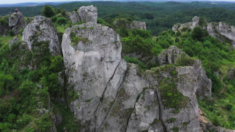 Drone-shot-of-rock-climbing-in-Zborow-Mountain-surrounded-by-natural-green-forest