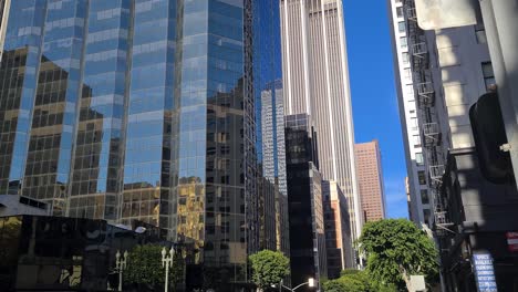 Downtown-Los-Angeles,-Traffic-on-Grand-Avenue-on-Hot-Sunny-Day,-Vehicles,-People-and-Modern-Buildings