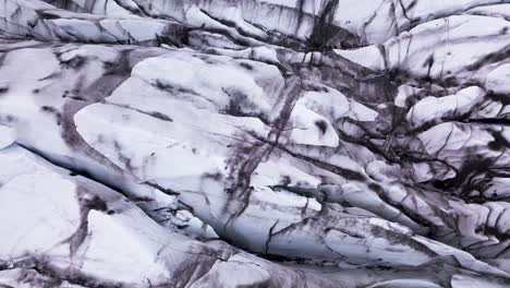 Close-top-down-drone-view-over-polar-ice-showing-beautiful-patterns-on-a-glacier-in-Iceland