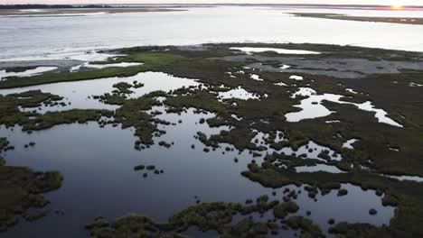 Swamp-wetlands-keep-the-waters-calm-on-otherside-of-beach-in-Chincoteague-Island-Virginia,-slow-motion