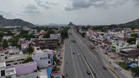 Elevated-view-of-the-highway-cutting-through-a-dense-forest-area,-showcasing-natural-beauty