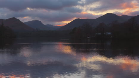 Vista-De-La-Superficie-Lisa-De-Derwentwater-Entre-Las-Montañas-De-Cumbria-Al-Atardecer