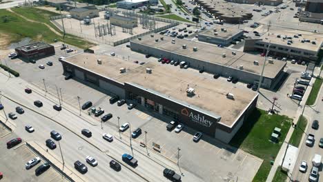 Aerial-view-of-Ashley-HomeStore-next-to-a-street-with-cars-driving-by