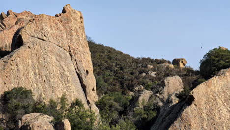 Trekking-path-reveals-Mammoth-Rock,-eagles-fly-by-natural-environment-California