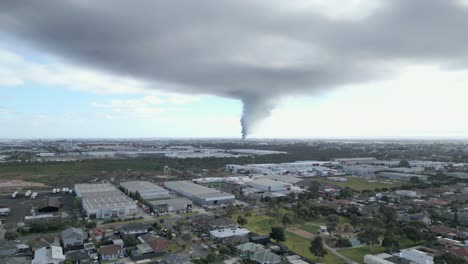 AERIAL,-Massive-Chemical-Factory-Fire-Billowing-Smoke-Over-Melbourne,-Australia