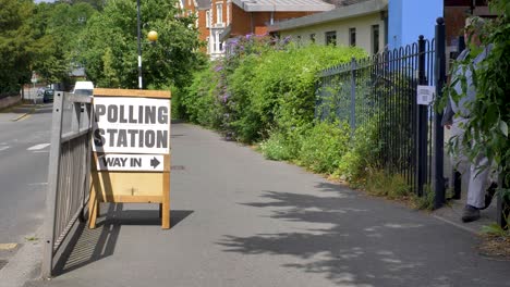 Polling-station-sign-outside-public-venue-on-a-sunny-day,-Exeter,-Devon,-UK,-June-2024