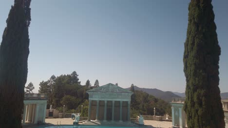 Gimbal-wide-booming-down-shot-of-the-ornamental-Neptune-Pool-at-Hearst-Castle-in-San-Simeon,-California